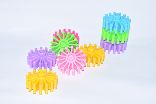 Colorful round plastic building blocks stacked and scattered isolated