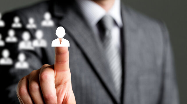 Businessman Finger Touching Glowing Virtual Human Profile Icon For Digital Recruitment Concept
