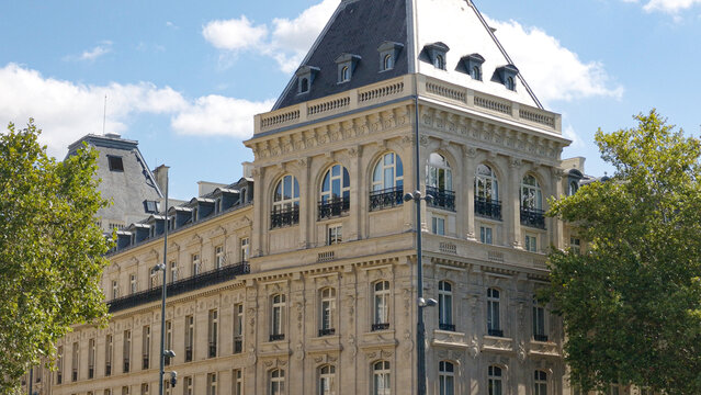 Haussmann style building showcasing its ornate facade, windows, and roof in Paris, France