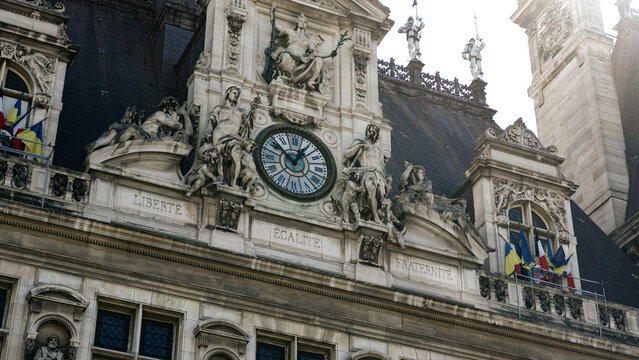Hotel de Ville facade with clock, sculptures, Liberte Egalite Fraternite inscription