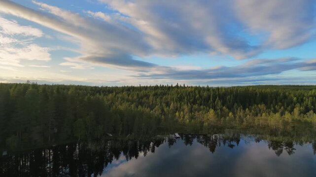 the video was taken by a drone in the lappish forest close to Rovaniemi at a lakeside, the drone flys over a wilderness hut called laavu in the summertime in Finland Lapland