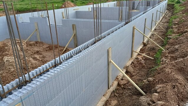 Construction of a reinforced concrete foundation using insulated concrete forms (ICF), reinforced with steel rebar.