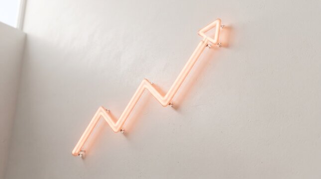 Rising Graph Neon Light: A neon graph shaped like an upward trending arrow casts a warm glow on a textured wall, symbolizing growth and progress.