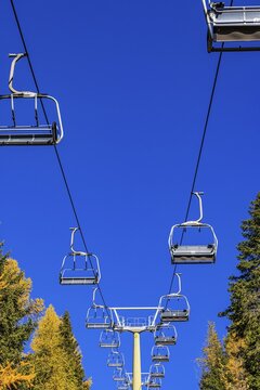 Chairlift, not in operation, against a blue sky, in autumnal landscape, skiing and hiking area Merano 2000, near Merano, South Tyrol, Italy