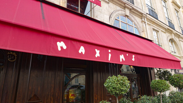 PARIS, FRANCE - SEPTEMBER 1, 2026 - Maxim's de Paris restaurant featuring its iconic red awning and classical architecture in the city