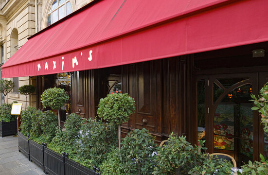 PARIS, FRANCE - SEPTEMBER 1, 2026 - Maxim's de Paris restaurant facade with red awning and ornate Art Nouveau entrance in Paris