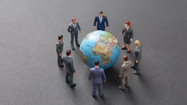 Businesspeople Around Globe Discussing Global Cooperation and Strategy