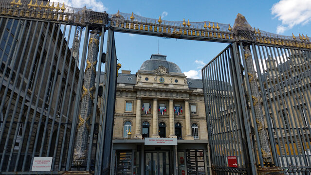 PARIS, FRANCE - SEPTEMBER 1, 2026 - Palais de Justice building viewed through the ornate security gate, an iconic landmark in Paris
