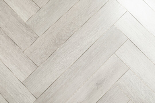 Light wooden flooring showcases elegant herringbone pattern