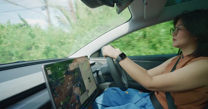 Business asian woman drive EV car use GPS navigator trnasport technology