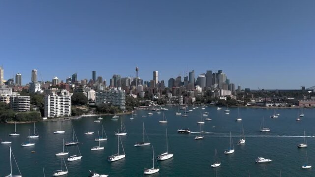 Sydney skyline from aerial view on beautiful sunny day. Camera tracks from Darling Point looking across to Elizabeth Bay and the Sydney CBD. Yachts and Motor Boats are on moorings.