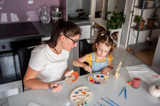 Mother and daughter make Halloween decorations at home