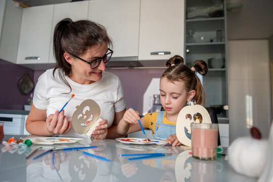 Mother and daughter make Halloween decorations at home