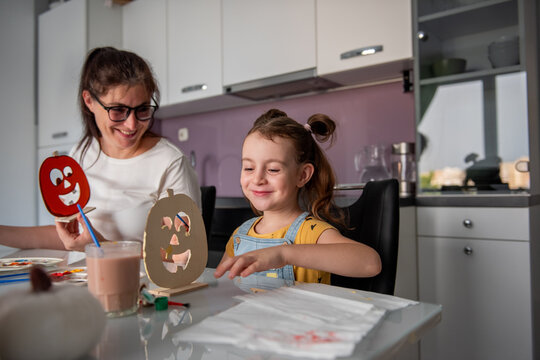Mother and daughter create Halloween decorations at home