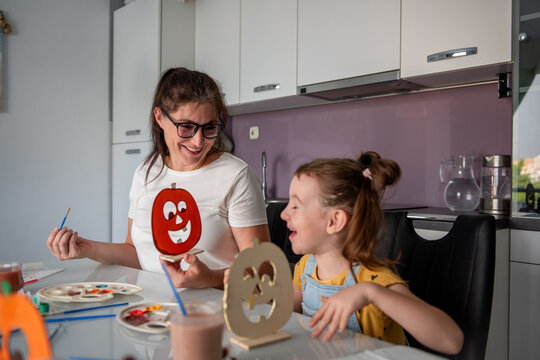 Mother and daughter make Halloween decorations at home