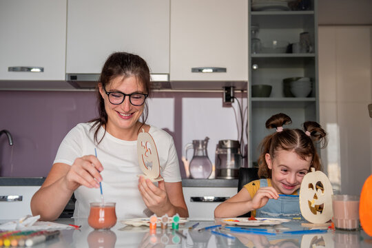 Mother and daughter make Halloween decorations at home