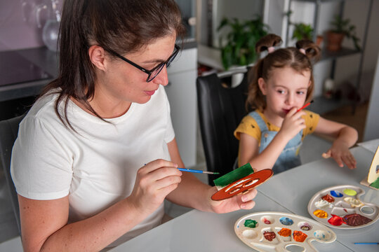 Mother and daughter make Halloween decorations at home