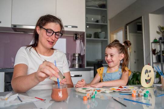 Mother and daughter create Halloween decorations at home