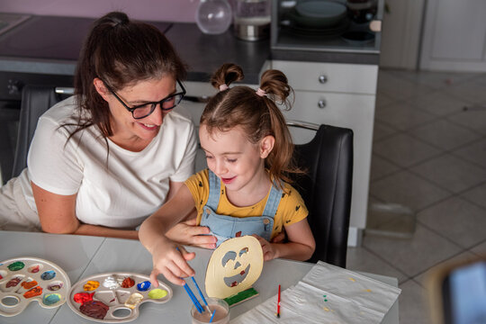 Mother and daughter make Halloween decorations at home