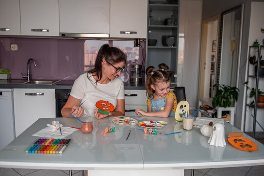 Mother and daughter make Halloween decorations at home