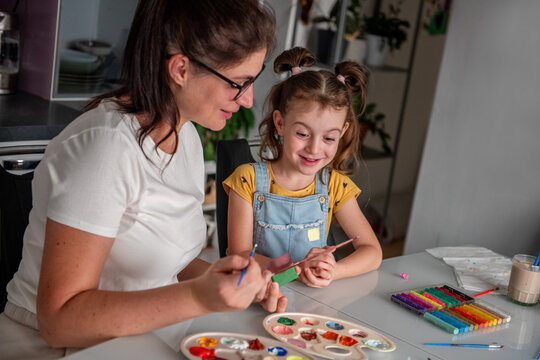 Mother and daughter make Halloween decorations at home
