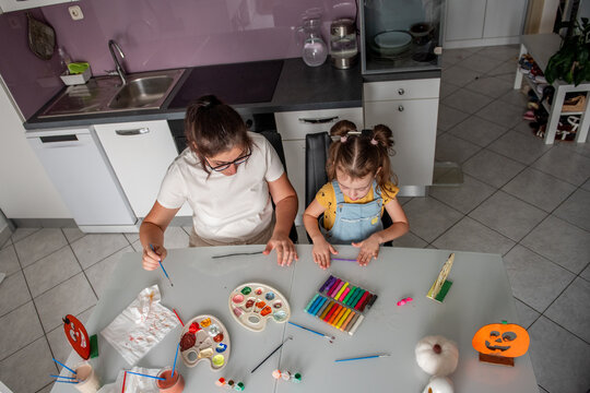 Mother and daughter create Halloween decorations at home