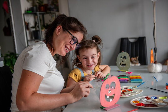 Mother and daughter create Halloween decorations at home