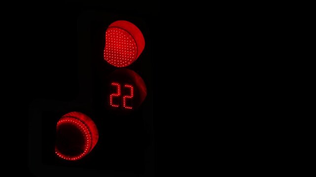 The countdown of red traffic light digits on a black background.
