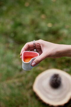 Hand holding tea cup during Chinese tea ceremony