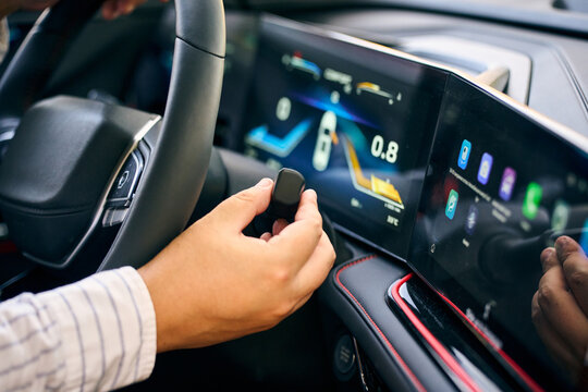Driver operate steering stalk beside car touchscreen display