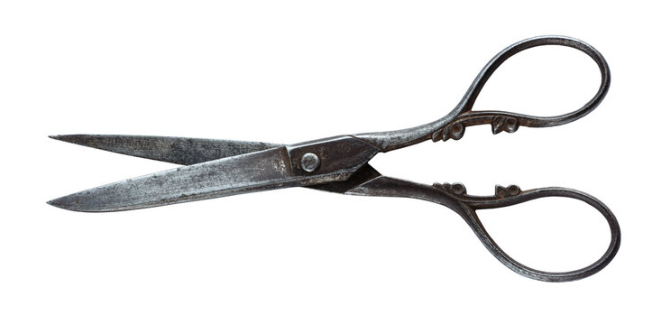 Antique 19th-century iron scissors with ornate handles and aged metal surface, isolated on a white background. Historical cutting tool with decorative vintage craftsmanship.