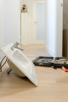 Remove wall-mounted sink before bathroom vanity installation
