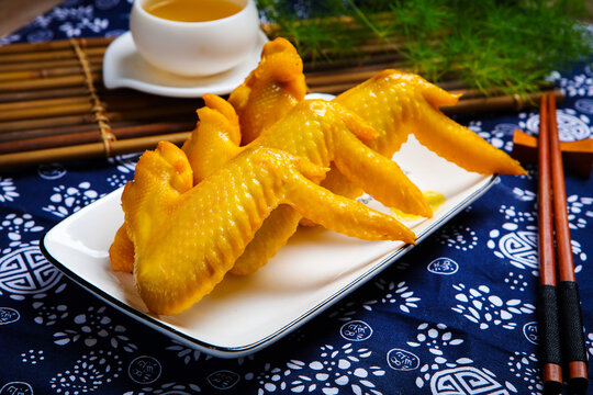 Golden salt baked chicken wings with white tea set and chopsticks