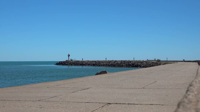 People stroll on the seaside pier. Valras, France .