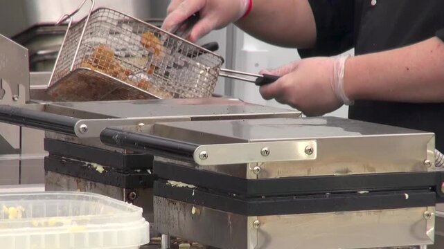 Close-up of chefs preparing food in an open outdoor kitchen