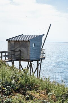 Close view of a traditional wooden carrelet fishing hut on stilts overlooking the Atlantic Ocean in Pornic, Loire-Atlantique, France.