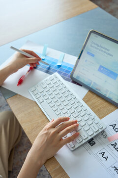 Woman's Hands Designing Website on Tablet with Stylus