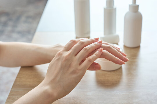 Young Womans Hands Applying Moisturizing Hand Cream