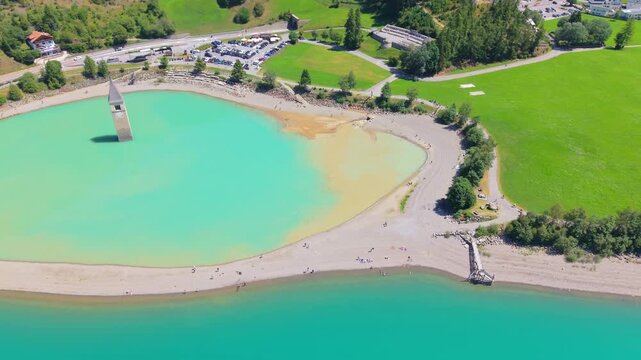 Aerial view of the iconic submerged church tower of Curon Lake Resia, in South Tyrol, Italy