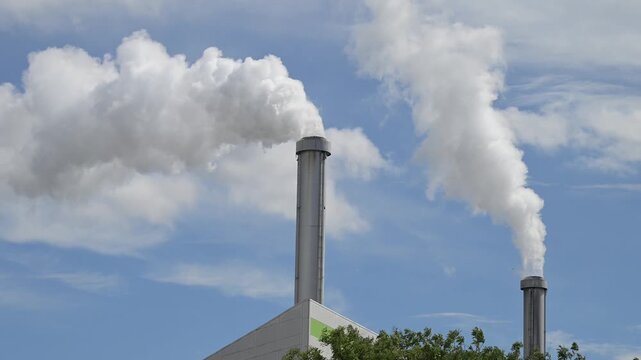 Smoke from chimney against a blue sky