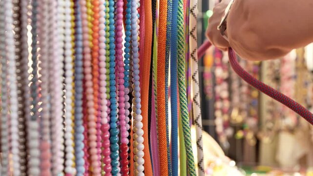 Colorful ropes and beads creating a vibrant pattern at a local market stall