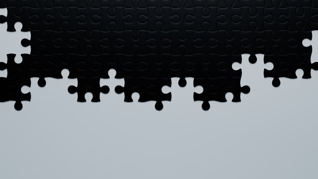 Partially Completed Black and White Jigsaw Puzzle Background with copy-space. Work in Progress Concept.