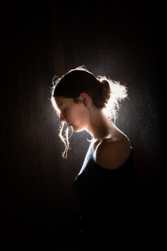 dramatic Profile portrait of a thoughtful teenager with backlighting