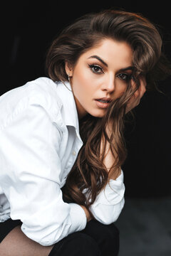 Beautiful woman with long hair gazes intensely at the camera