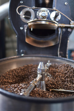 close up view of coffee beans roasting in machine