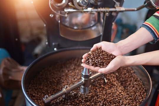 close up view of coffee beans roasting in machine