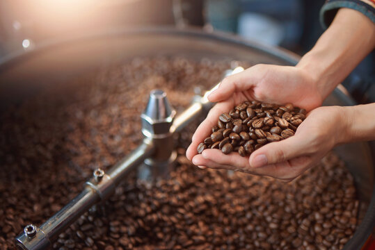 close up view of coffee beans roasting in machine