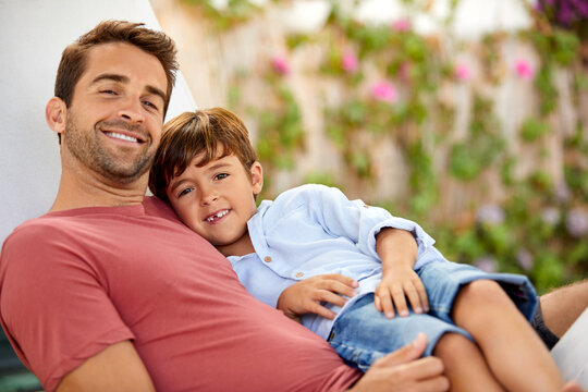 Relax, dad and child in backyard with portrait, family connection and chill together on day off. Rest, parent and boy in hammock with healthy relationship, happy moment and good mood on weekend break