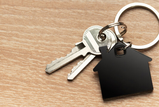 Keys with house shape keychain representing home ownership