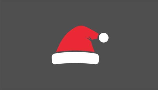 Christmas santa claus red hat with a white fluffy trim and pompom centered on a solid dark grey background.